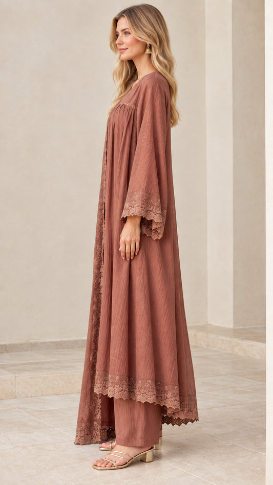 Side profile of model in dusty rose crinkle tunic, wide-leg trousers, and duster set