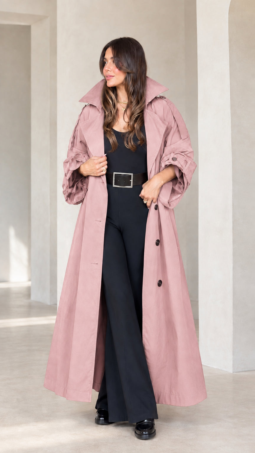 Front view of woman wearing dusty pink maxi trench coat with gathered sleeves