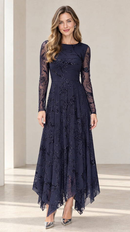 Front view of woman wearing navy blue sequin embroidered long sleeve evening dress with handkerchief hem