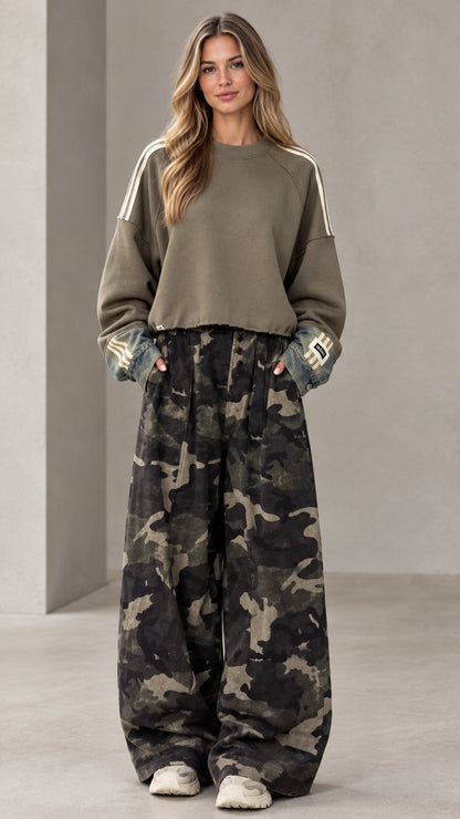 Front full-length view of woman wearing olive green cropped sweatshirt and camouflage wide-leg pants set