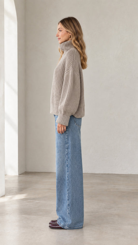Side profile view of taupe chunky ribbed knit high neck sweater