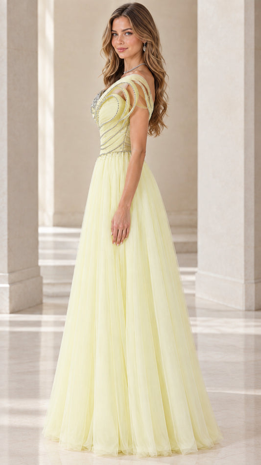 Side profile of model in pastel yellow one-shoulder pleated tulle formal gown
