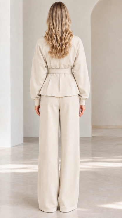 Back full-length view of beige two-piece peplum and wide-leg pants set