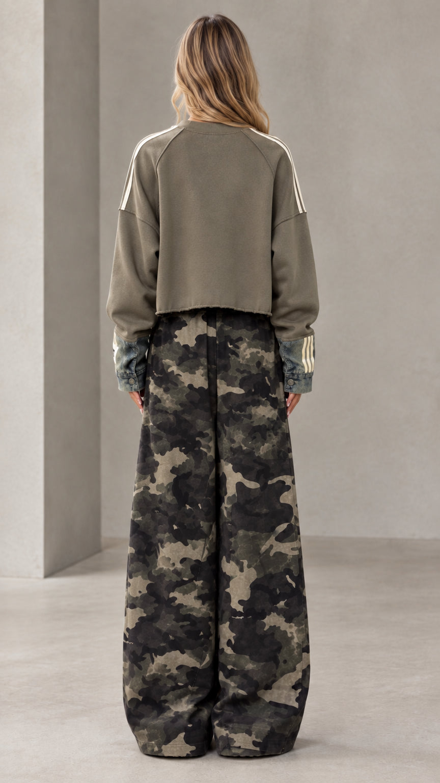 Back full-length view of olive green cropped sweatshirt and matching wide-leg camo pants