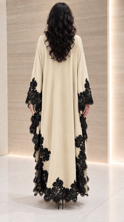 Back view of cream draped maxi dress showing flowing cape sleeves and lace details