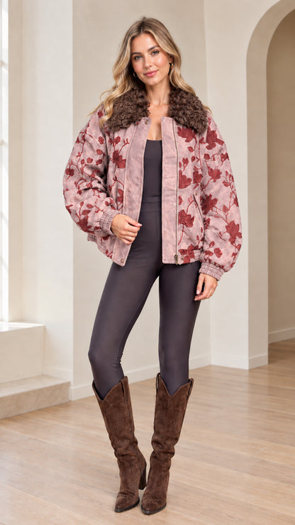 Front view of woman wearing Dusty Pink floral embroidered bomber jacket with faux fur collar