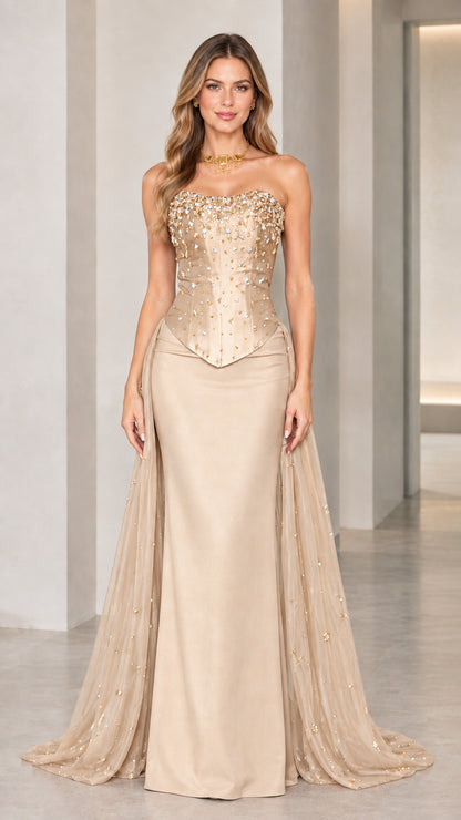 Model wearing champagne gold strapless beaded corset evening gown
